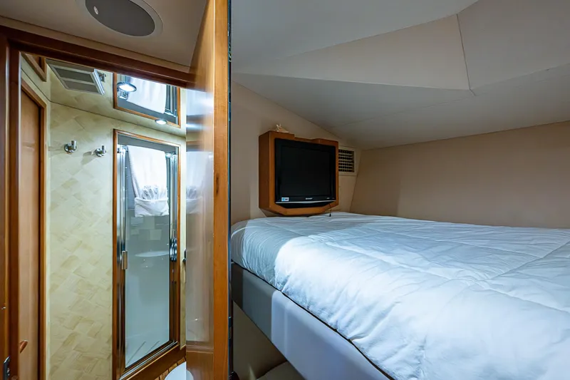 Slide: The Image of Cozy bedroom with TV and ensuite bathroom in 2008 Hatteras 60 GT yacht. - 34