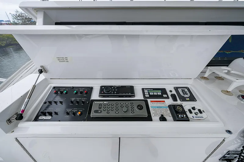 Slide: The Image of Control panel of a 2008 Hatteras 60 GT yacht, featuring navigation and communication equipment. - 40