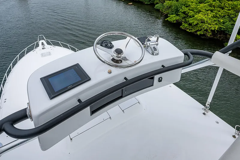 Slide: The Image of Helm of 2008 Hatteras 60 GT yacht with steering wheel and navigation screen. - 44