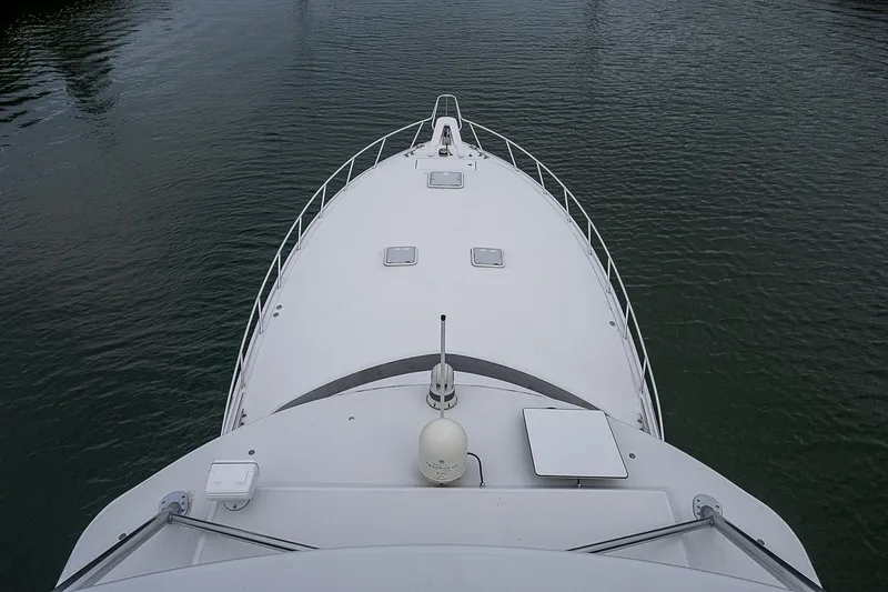 Slide: The Image of Bow view of 2008 Hatteras 60 GT yacht on calm water. - 45