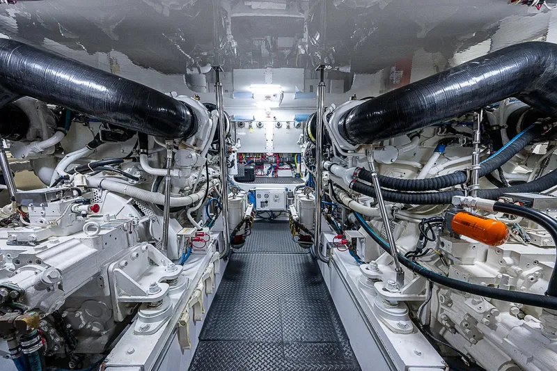 Slide: The Image of Engine room of 2008 Hatteras 60 GT yacht, showcasing complex machinery and piping. - 47