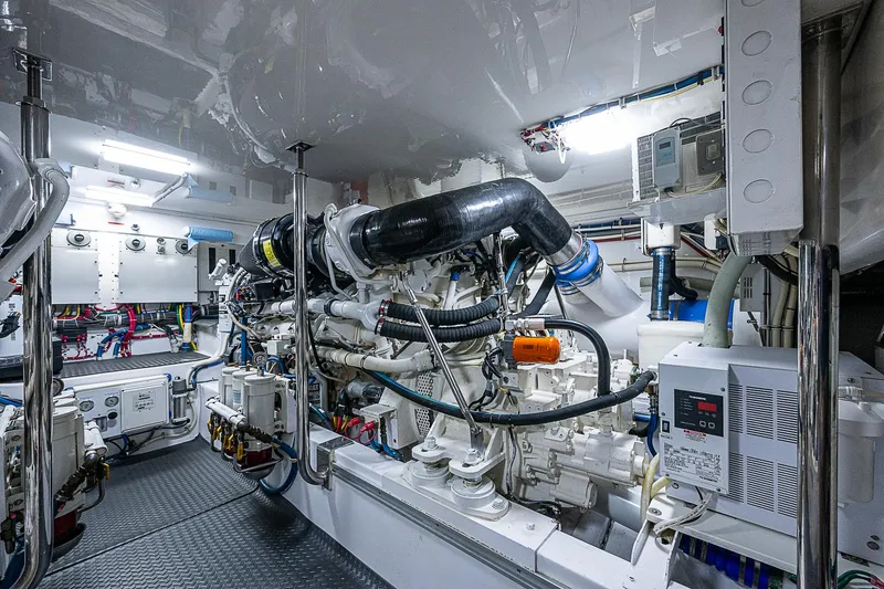 Slide: The Image of Engine room of 2008 Hatteras 60 GT yacht, showcasing complex machinery and equipment. - 48