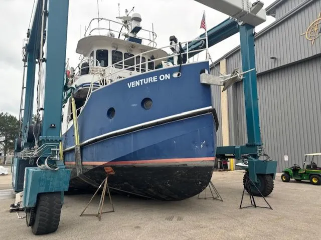 Slide: The Image of 1991 Florida Bay Coasters 53 Trawler in dry dock, named "Venture On," undergoing maintenance. - 5