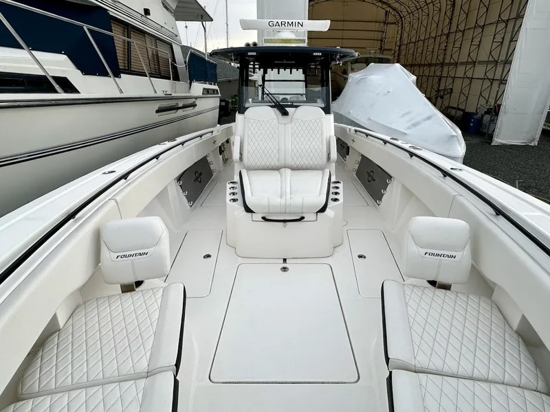 Slide: The Image of 2023 Fountain Bluewater 38 Tournament Edition boat interior with white seating and Garmin equipment. - 10