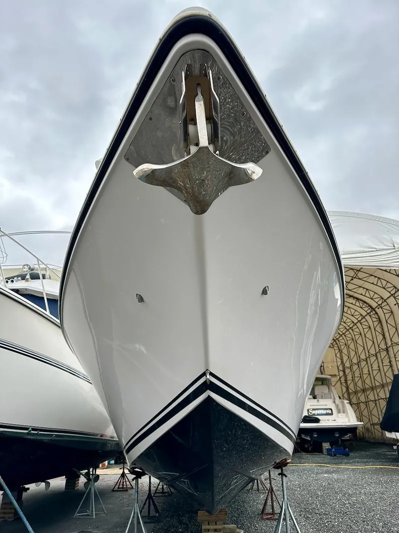 Slide: The Image of 2023 Fountain Bluewater 38 Tournament Edition boat, front view, docked under cloudy sky. - 3