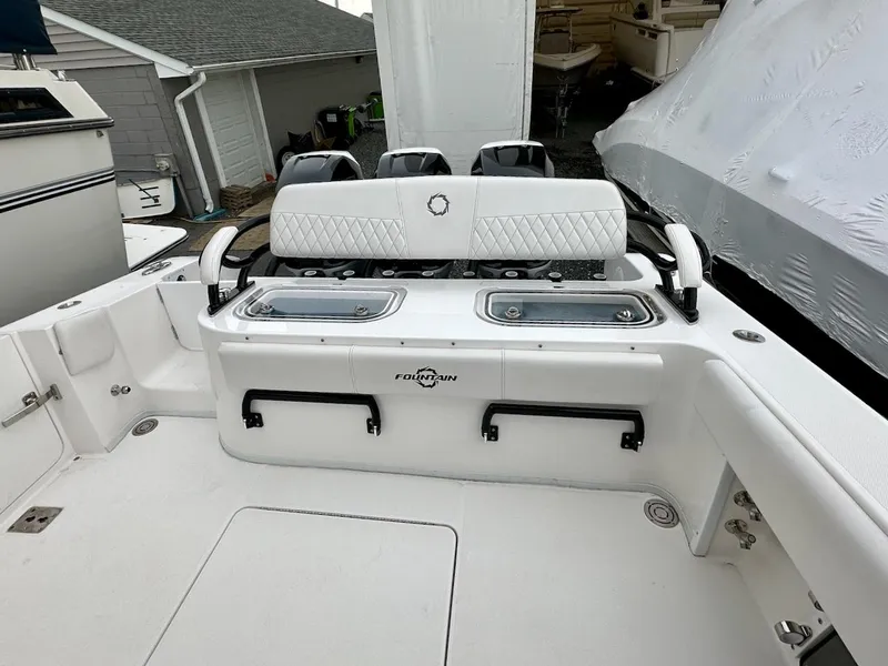 Slide: The Image of 2023 Fountain Bluewater 38 Tournament Edition boat interior with seating and storage. - 5