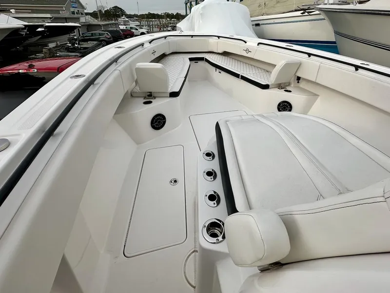 Slide: The Image of 2023 Fountain Bluewater 38 Tournament Edition boat interior with white seating and storage compartments. - 9