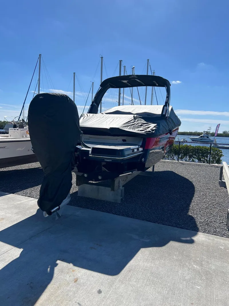 Slide: The Image of 2021 Monterey 275 Super Sport boat docked under clear blue sky. - 17