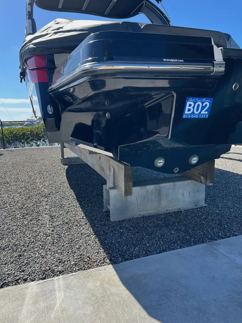 Slide: The Image of 2021 Monterey 275 Super Sport boat on a stand, rear view, outdoors. - 18