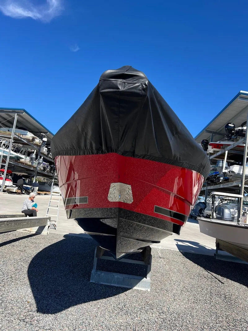 Slide: The Image of 2021 Monterey 275 Super Sport boat, red hull, covered, in storage facility. - 5