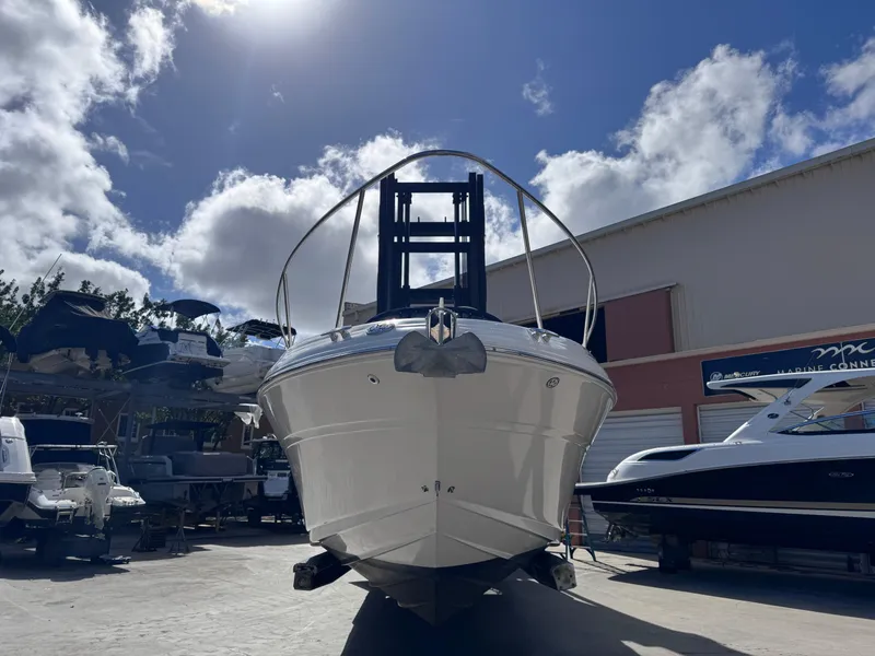 Slide: The Image of 2005 Sea Ray 280 Sundancer boat in a marina under a bright blue sky. - 1