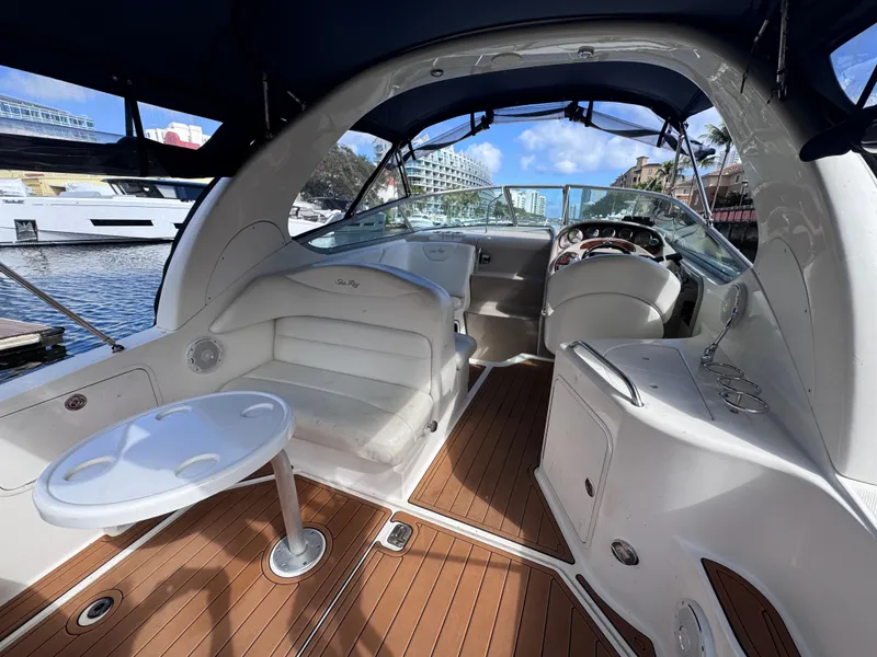 Slide: The Image of 2005 Sea Ray 280 Sundancer interior with seating and helm, docked at marina. - 20