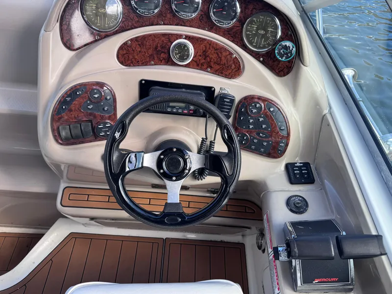 Slide: The Image of 2005 Sea Ray 280 Sundancer dashboard with steering wheel and control panel. - 24