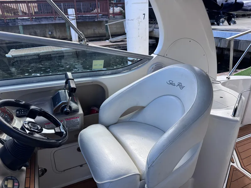 Slide: The Image of 2005 Sea Ray 280 Sundancer helm with steering wheel and captain's chair. - 25
