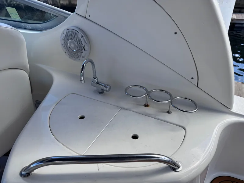 Slide: The Image of 2005 Sea Ray 280 Sundancer boat interior with sink, cup holders, and speaker. - 27