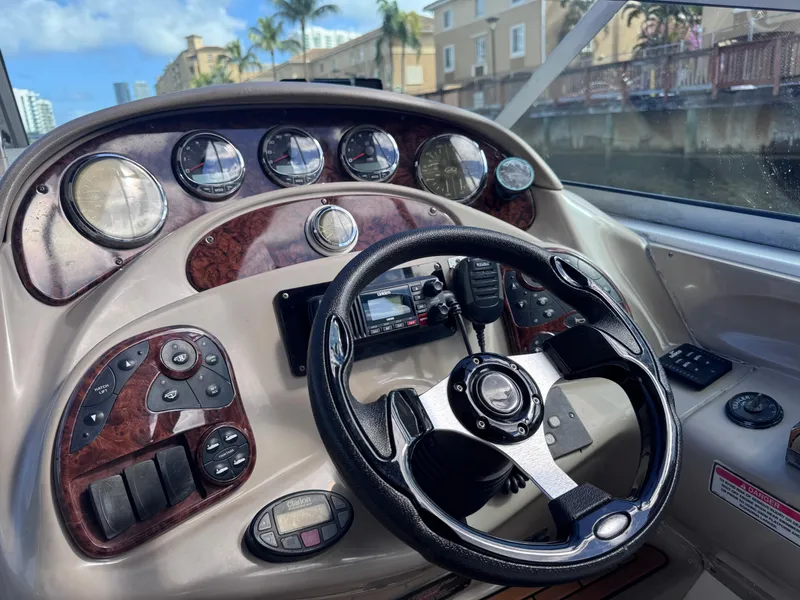 Slide: The Image of 2005 Sea Ray 280 Sundancer dashboard with steering wheel and control panel. - 28