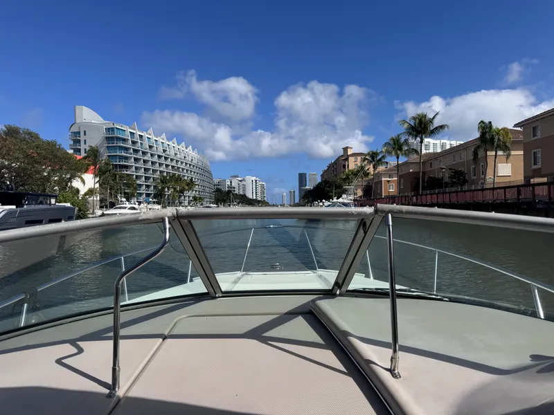 Slide: The Image of Bow view from a 2005 Sea Ray 280 Sundancer cruising through a scenic urban waterway. - 30