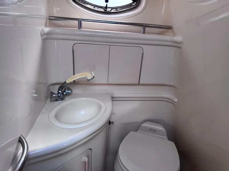 Slide: The Image of Compact bathroom in 2005 Sea Ray 280 Sundancer boat with sink and toilet. - 31