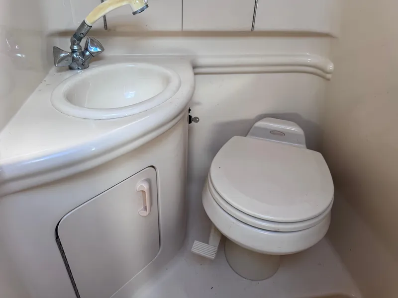 Slide: The Image of Compact bathroom in 2005 Sea Ray 280 Sundancer with sink and toilet. - 35