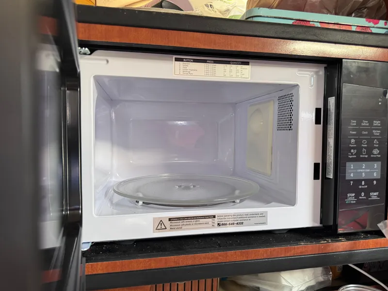 Slide: The Image of Open microwave oven with digital controls, inside a 2005 Sea Ray 280 Sundancer boat. - 36