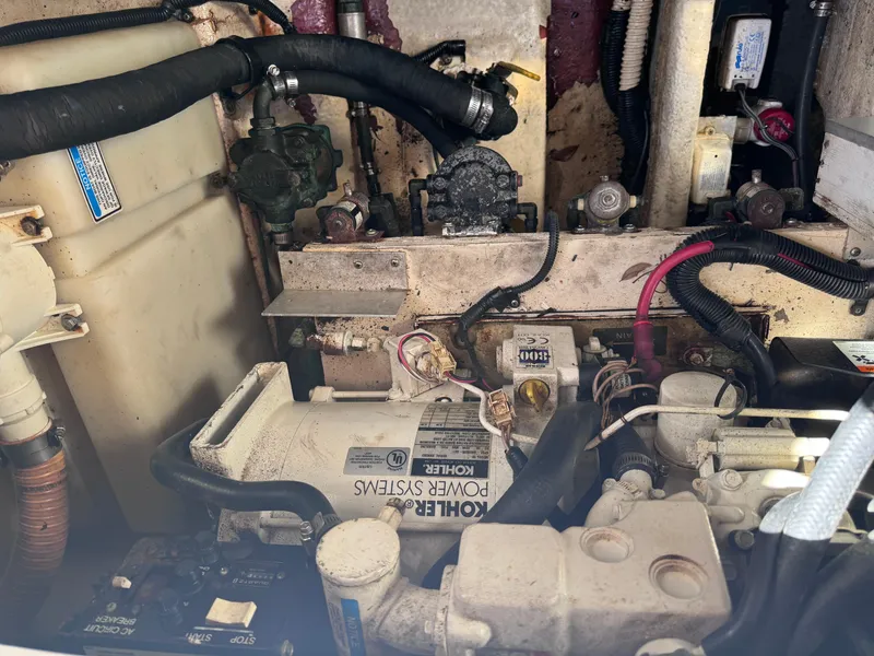 Slide: The Image of Engine compartment of a 2005 Sea Ray 280 Sundancer boat, featuring mechanical components and wiring. - 41
