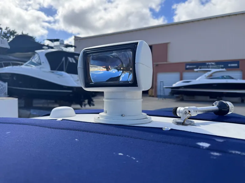 Slide: The Image of 2005 Sea Ray 280 Sundancer with radar, docked near other boats under cloudy sky. - 47