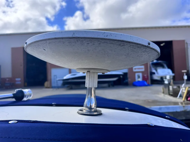 Slide: The Image of 2005 Sea Ray 280 Sundancer radar dome on boat, with marina background. - 48