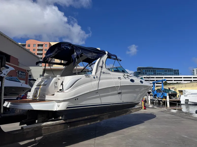 Slide: The Image of 2005 Sea Ray 280 Sundancer boat docked under clear blue sky. - 9