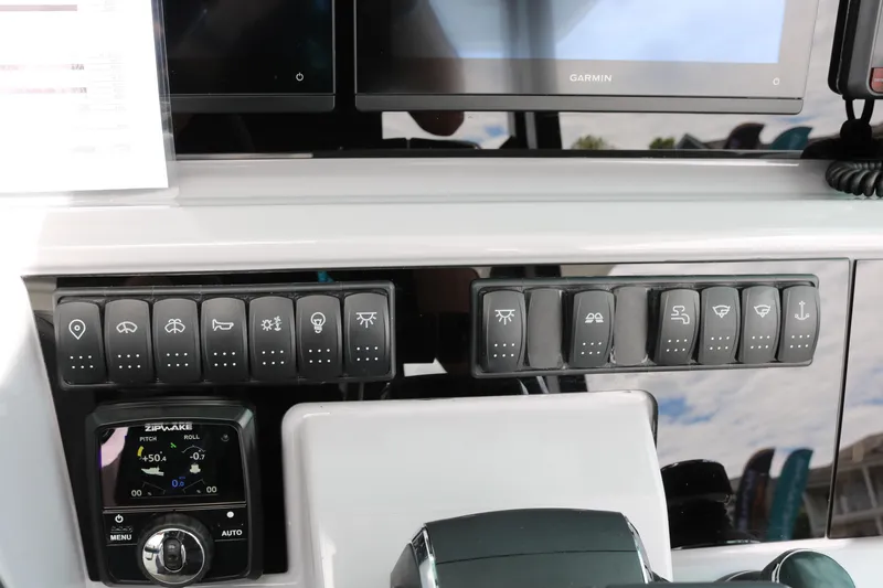 Slide: The Image of Control panel of 2026 Jeanneau Leader 10.5 WA Series 2 with switches and Garmin display. - 17