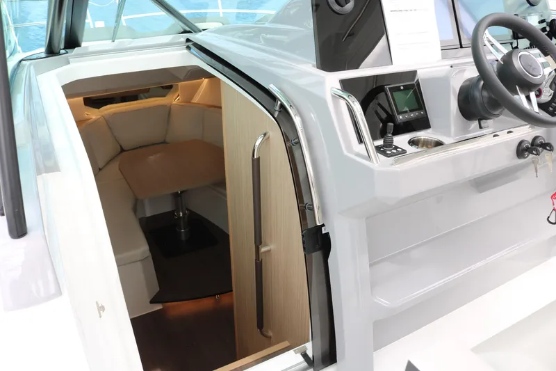 Slide: The Image of 2026 Jeanneau Leader 10.5 WA Series 2 cabin interior with helm and seating area. - 19
