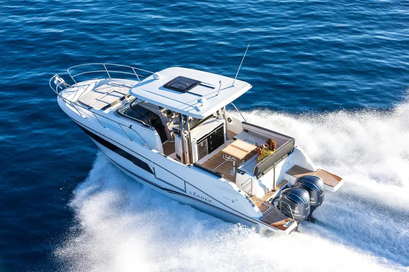 Slide: The Image of 2025 Jeanneau Leader 10.5 WA Series 2 cruising on open water, showcasing sleek design and powerful engines. - 2