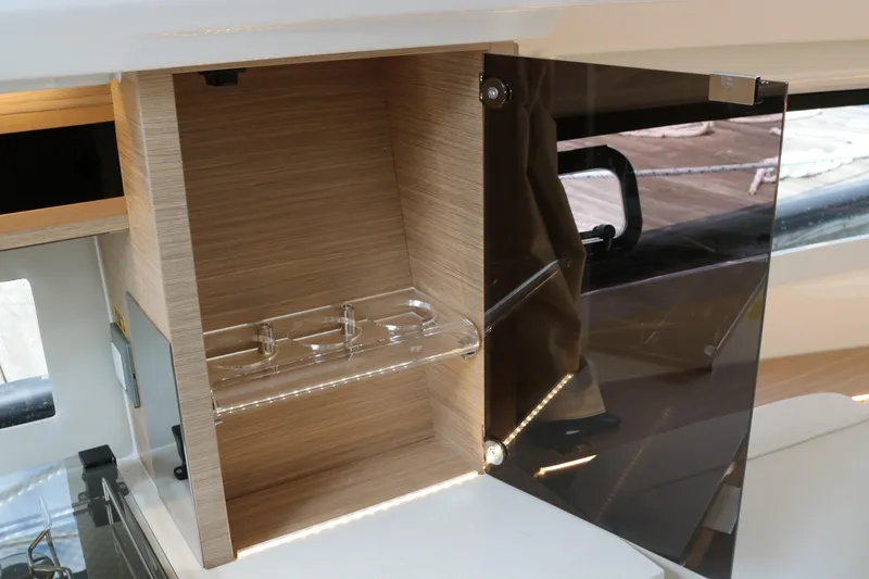 Slide: The Image of Interior cabinet of 2026 Jeanneau Leader 10.5 WA Series 2 with glass holder. - 24