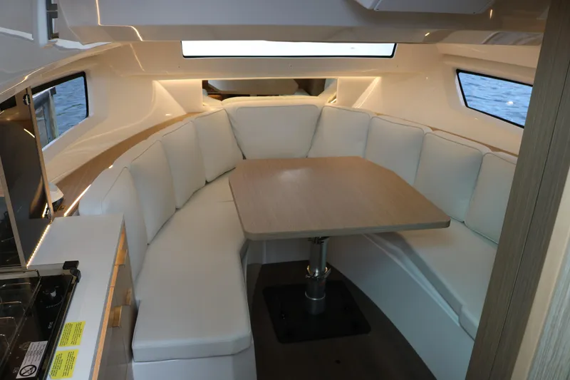 Slide: The Image of Interior of 2026 Jeanneau Leader 10.5 WA Series 2 with cozy seating and dining table. - 25