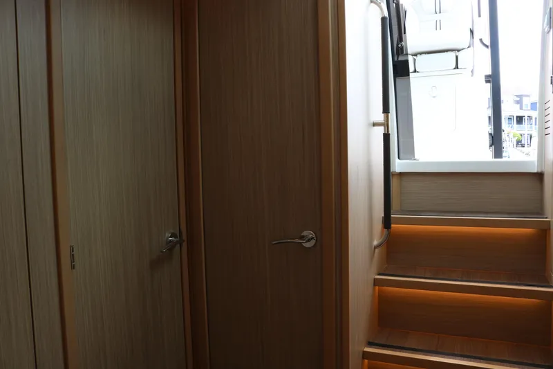 Slide: The Image of Interior view of 2026 Jeanneau Leader 10.5 WA Series 2 yacht with wooden stairs. - 26