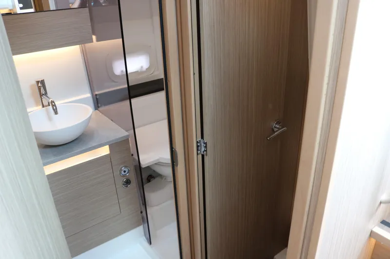 Slide: The Image of 2026 Jeanneau Leader 10.5 WA Series 2 interior bathroom with modern sink and wooden cabinetry. - 27