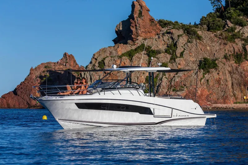 Slide: The Image of 2025 Jeanneau Leader 10.5 WA Series 2 boat cruising near rocky coastline. - 3