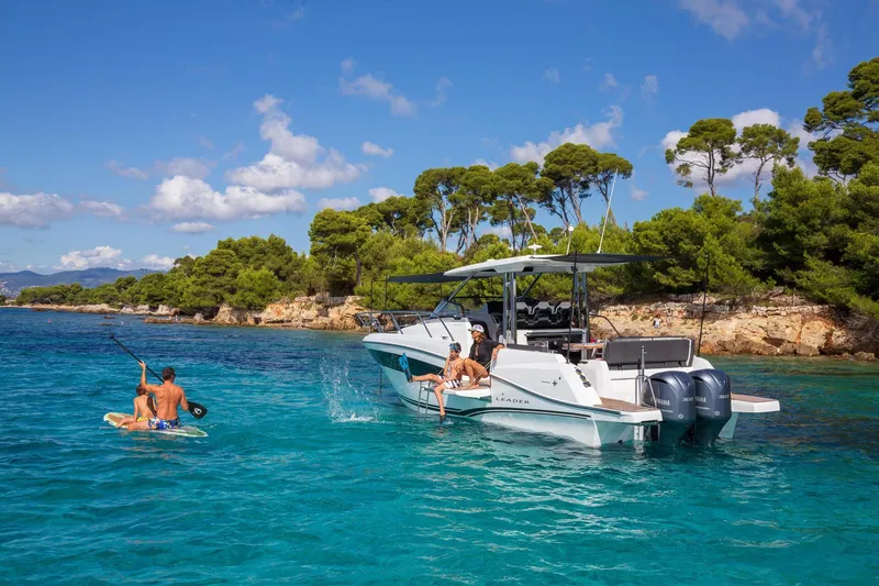 Slide: The Image of 2025 Jeanneau Leader 10.5 WA Series 2 in turquoise waters, people enjoying water activities. - 4