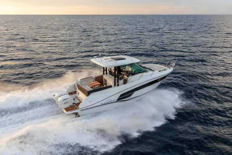Slide: The Image of 2025 Jeanneau Leader 10.5 WA Series 2 cruising on open water at sunset. - 6
