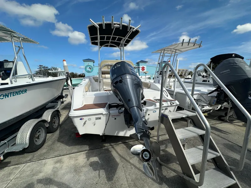 Slide: The Image of 2018 Sea Fox 186 Commander boat with outboard motor, docked under a clear blue sky. - 3