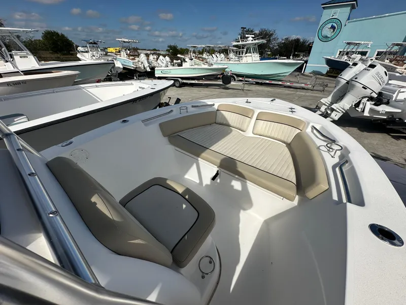 Slide: The Image of 2018 Sea Fox 186 Commander boat interior with seating, docked under clear skies. - 5