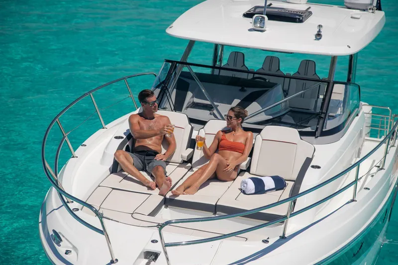 Slide: The Image of Couple relaxing on 2025 Jeanneau Leader 12.5 WA yacht in clear turquoise water. - 10