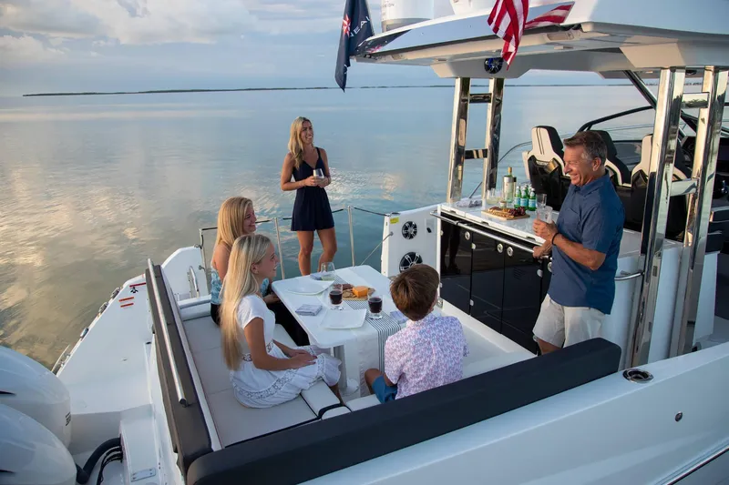 Slide: The Image of Family enjoying a sunset cruise on a 2025 Jeanneau Leader 12.5 WA yacht. - 11