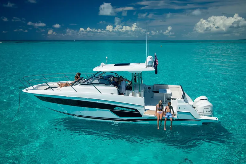 Slide: The Image of 2025 Jeanneau Leader 12.5 WA cruising on clear turquoise waters. - 2