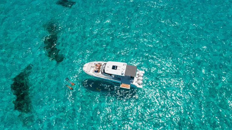 Slide: The Image of Aerial view of 2025 Jeanneau Leader 12.5 WA yacht on clear turquoise water. - 4