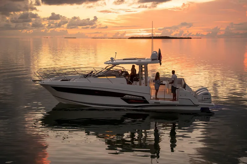 Slide: The Image of 2025 Jeanneau Leader 12.5 WA boat cruising at sunset on calm waters. - 5