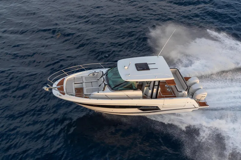 Slide: The Image of 2025 Jeanneau Leader 12.5 WA cruising on open water, aerial view. - 8
