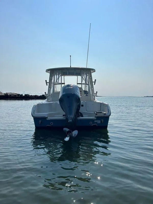 Slide: The Image of 2018 Grady-White Freedom 255 boat on calm water, rear view. - 10