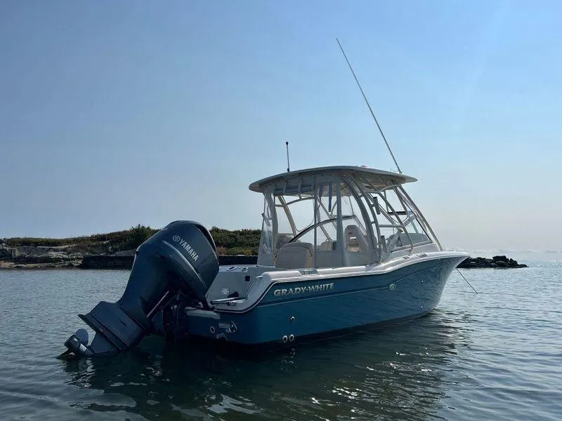 Slide: The Image of 2018 Grady-White Freedom 255 boat on calm water, featuring Yamaha outboard motor. - 11