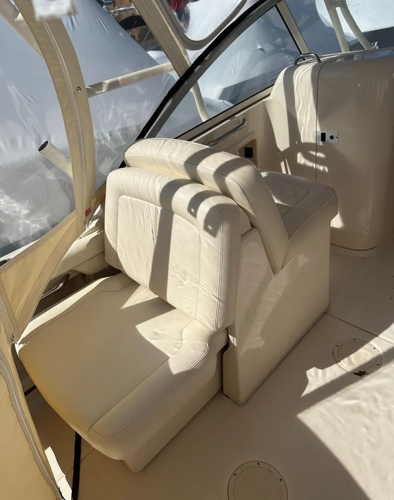Slide: The Image of 2018 Grady-White Freedom 255 boat interior with beige seating and canopy. - 16