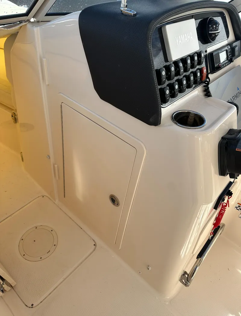Slide: The Image of 2018 Grady-White Freedom 255 boat console with control panel and storage compartment. - 21